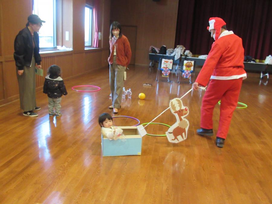 サンタクロース館長にソリに乗せてもらって遊ぶ様子