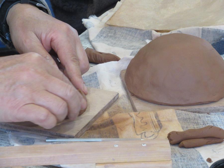 茶碗の形を整える人の写真